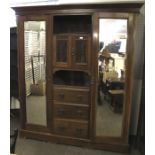 An Art Nouveau mahogany triple wardrobe.