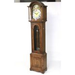 A contemporary longcase clock. The brass