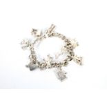 A silver charm bracelet with a heart loc