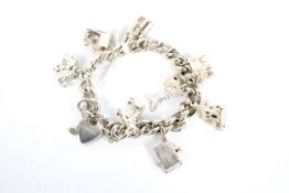 A silver charm bracelet with a heart loc