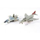 Two diecast military fighter jet aircraft models. An F-4 Phantom on stand and a Chinese MiG 29.