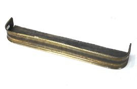 A 20th century brass fender. With pierce