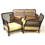 A 1930s bergere style three piece suite.