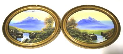A pair of early 20th century oils depicting Scottish mountains unsigned set in gilt oval frames.