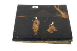 A Japanese postcard album with views of Japan Hong Kong and London some hand painted set in a