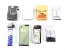 An assortment of seven novelty lighters including Zippo and Storm King and a match box holder.
