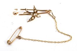 A rose gold brooch modelled as a swallow in flight set with seed pearls, 1.3 gram.