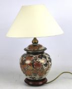 A ceramic Oriental bulbous shaped table lamp with shade