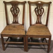 A pair of Georgian oak Chippendale style dining chairs.