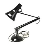 A black metal anglepoise desk lamp.