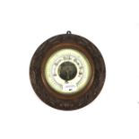 A circular aneroid wall barometer by D. Frost Winchester.