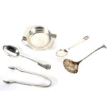 An assortment of silver items including an ashtray, sugar ladle, sugar snips,