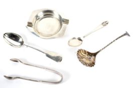 An assortment of silver items including an ashtray, sugar ladle, sugar snips,