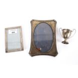 Two silver photo frames and a trophy. One stamped Tiffany & Co Italy.