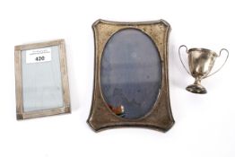 Two silver photo frames and a trophy. One stamped Tiffany & Co Italy.
