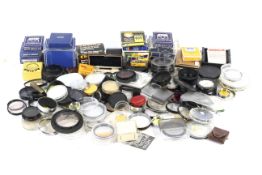 A large collection of camera lens filters and attachments.