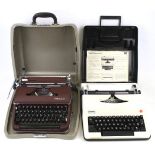 Two vintage Olympia portable manual typewriters.