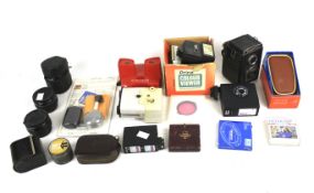 An assortment of camera accessories and two cameras.