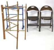 Two wooden folding chairs and two clothes rails.