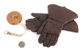 A pair of vintage driving gauntlets, a tape measure and silver lidded box.