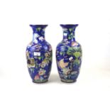 A pair of contemporary Chinese polychrome vases.