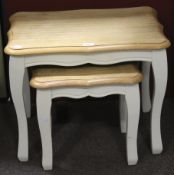 A nest of two tables with shaped top and painted base, L58.5cm x D41cm x H47.5cm.