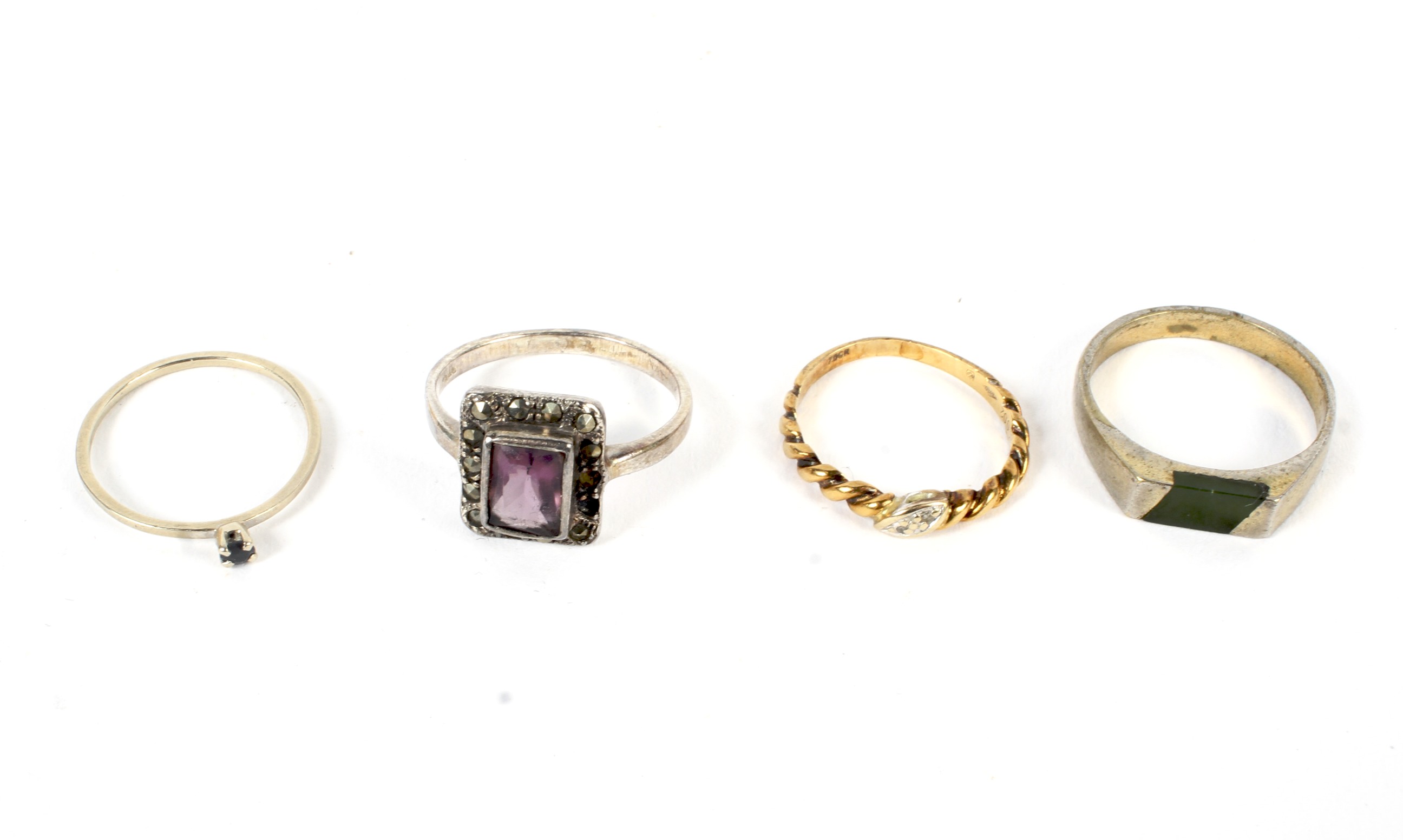 four assorted dress rings including gold all set with stones and one with rope twist shank.