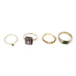 four assorted dress rings including gold all set with stones and one with rope twist shank.