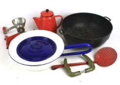 An assortment of kitchenalia. Including enamel pans, a cast iron pan, vintage mincer etc.