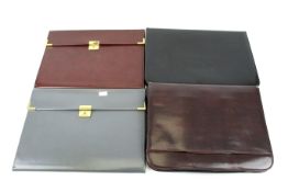 Four leather briefcases.