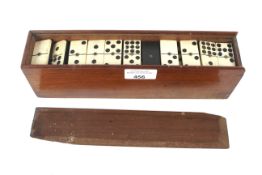 A set of bone and ebony dominos and a wooden handled corkscrew.