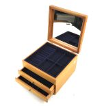 A contemporary beech effect jewellery box.