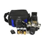An assortment of cameras, lenses and accessories. .