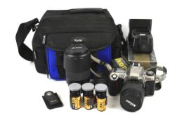 An assortment of cameras, lenses and accessories. .