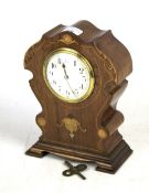 An Edwardian Sheraton revival mantle clock.