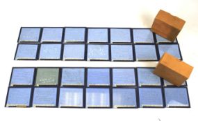 Two sets of fourteen magic lantern glass slides.