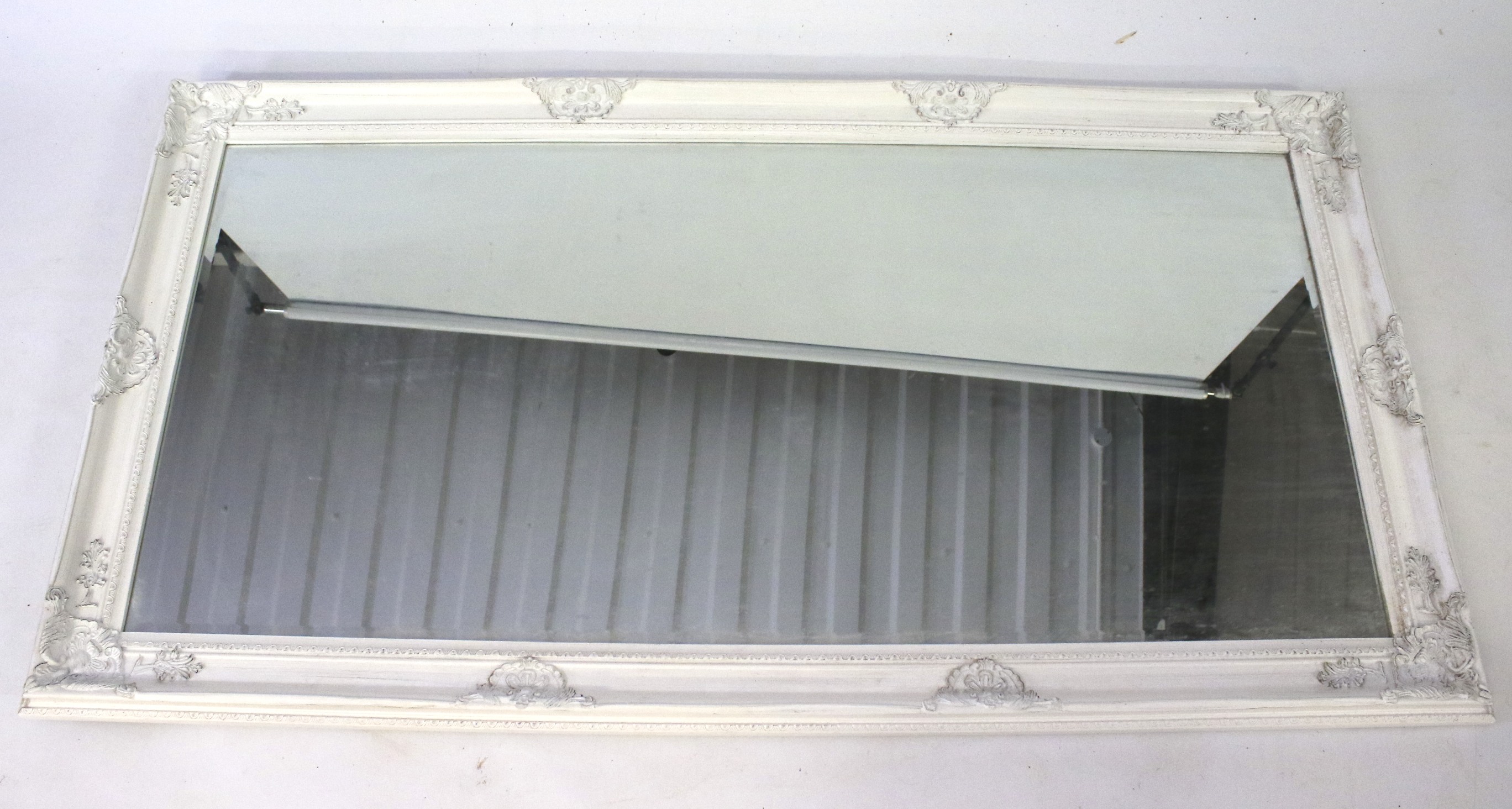 A contemporary French style bevelled edge wall mirror.