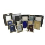 Thirteen contemporary easel strut back photo frames.