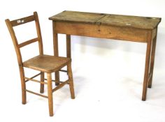 A vintage pine school double desk and a chair.