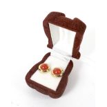 A pair of yellow metal and coral stud earrings. Stamped '375',