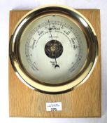 A contemporary brass barometer.