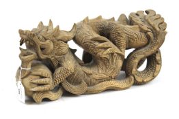A carved wooden sculpture of an Oriental cloud dragon.