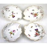 Four KPM porcelain leaf shape dishes. All with gilt rims and floral details on a white ground, L19.