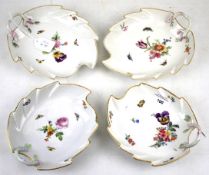 Four KPM porcelain leaf shape dishes. All with gilt rims and floral details on a white ground, L19.