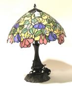 A leaded glass Tiffany style table lamp the shade with floral decoration H54cm.