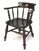 A late 19th century dark wood elm seated smokers bow chair.