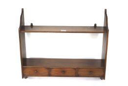 An Edwardian mahogany wall rack.