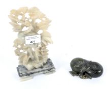 A jade carving of fruit together with a carved soap stone depicting a crane,