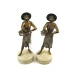 Two gilt spelter figures on marble plinth.