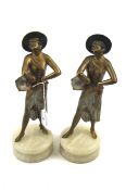 Two gilt spelter figures on marble plinth.